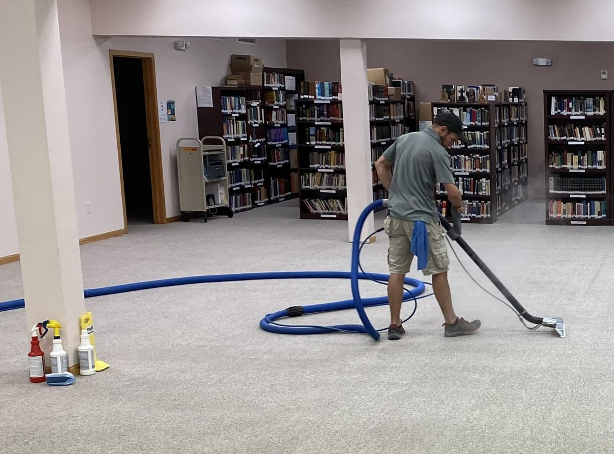 Fresh Start technician cleaning carpet in a library